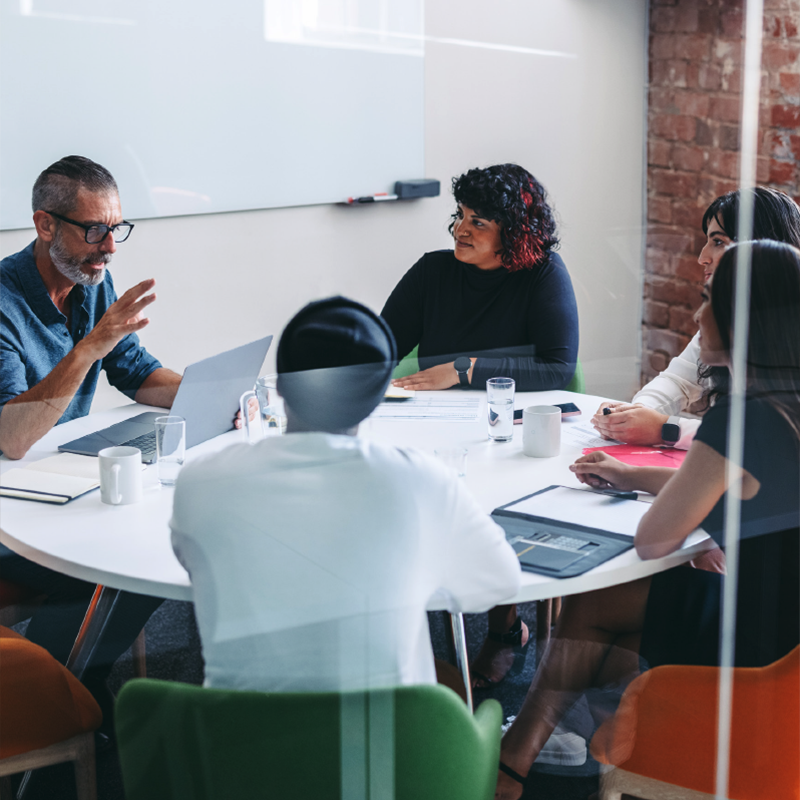 group of people in a discussion at a meeting table